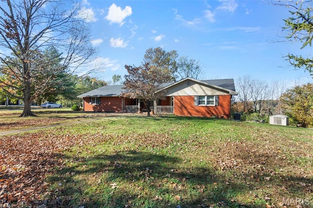 11 Schonhoff Cpe, Girardeau, MO 63703 - view of front of property with a shed, a front yard, an outbuilding, covered porch, and brick siding