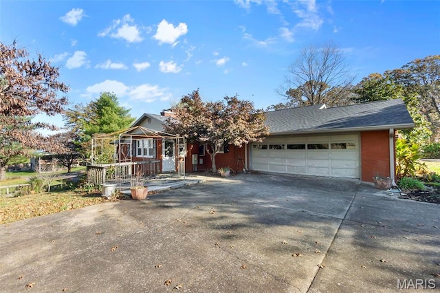 11 Schonhoff Cpe, Girardeau, MO 63703 - view of front of house with concrete driveway, a garage, and brick siding