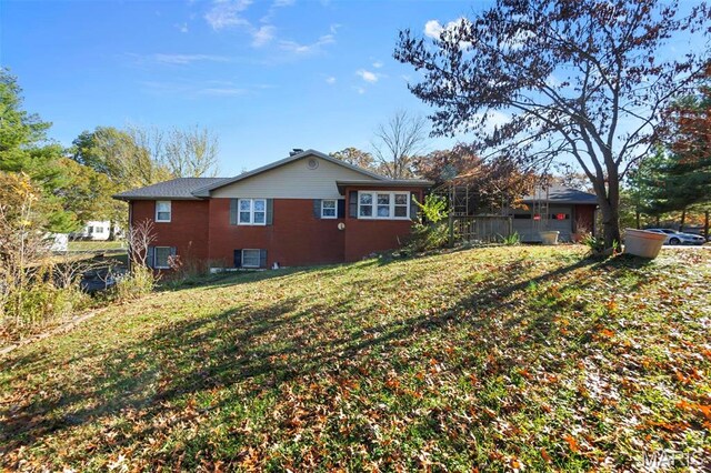 11 Schonhoff Cpe, Girardeau, MO 63703 - view of side of property with central AC, a yard, and brick siding