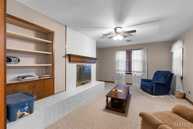 11 Schonhoff Cpe, Girardeau, MO 63703 - living room with a textured ceiling, ceiling fan, a brick fireplace, baseboards, and carpet flooring
