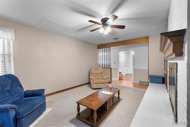 11 Schonhoff Cpe, Girardeau, MO 63703 - living area featuring a fireplace, ceiling fan, a textured ceiling, and baseboards