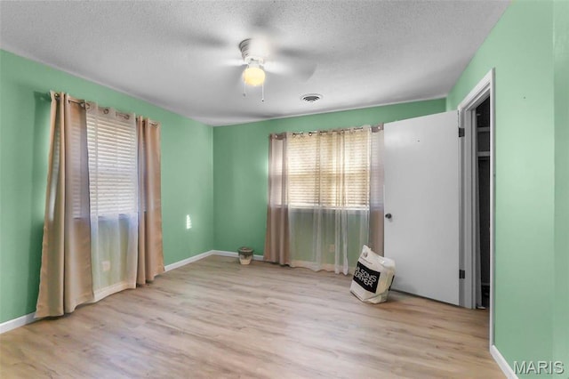 11 Schonhoff Cpe, Girardeau, MO 63703 - unfurnished bedroom with wood finished floors, a textured ceiling, baseboards, and ceiling fan