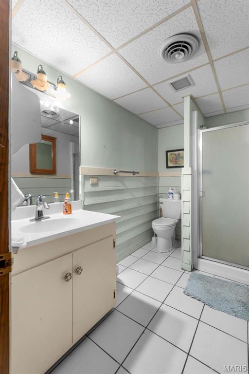 11 Schonhoff Cpe, Girardeau, MO 63703 - full bathroom with a stall shower, a paneled ceiling, vanity, toilet, and tile patterned floors
