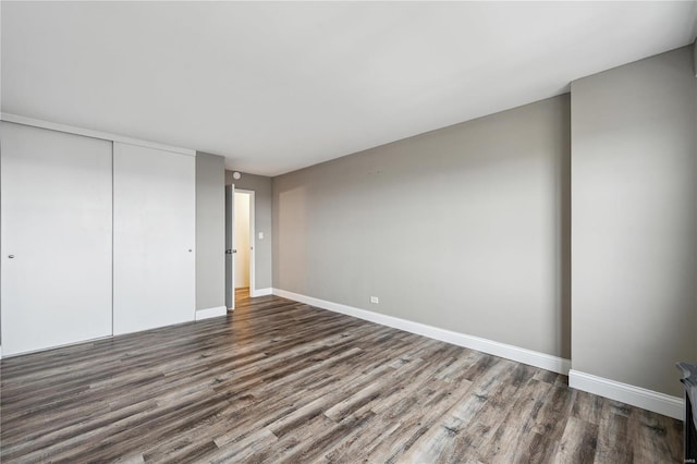 4466 W Pine Blvd Unit 22G, Saint Louis, MO 63108 - unfurnished bedroom with wood finished floors, a closet, and baseboards