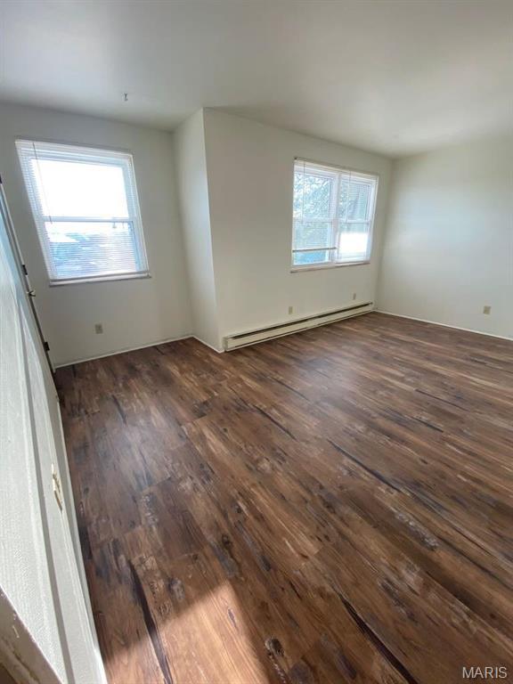 753 Rozier St, Saint Genevieve, MO 63670 - empty room with a baseboard radiator and dark wood-style floors