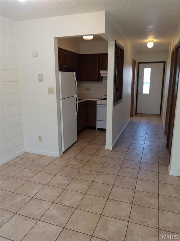 753 Rozier St, Saint Genevieve, MO 63670 - kitchen with white appliances, light tile patterned flooring, baseboards, and light countertops