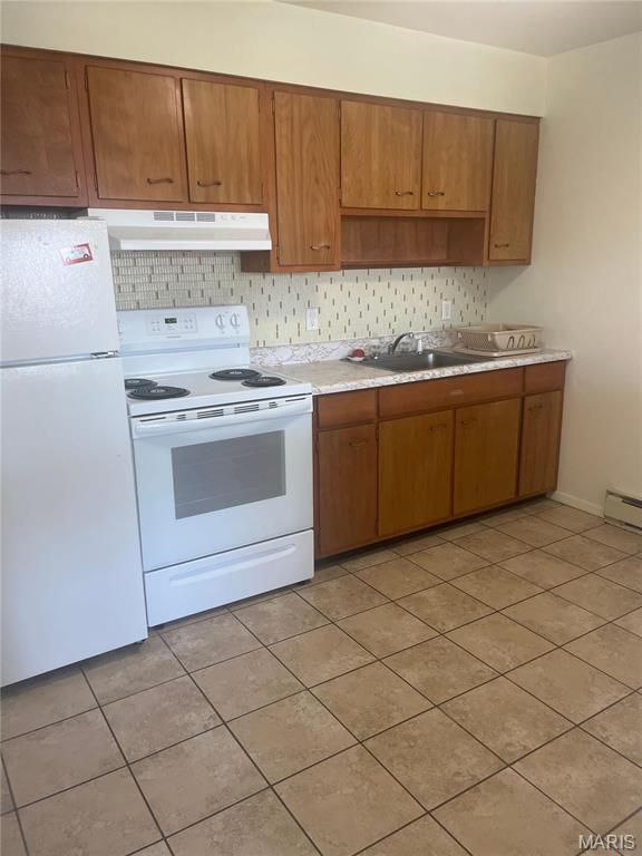 753 Rozier St, Saint Genevieve, MO 63670 - kitchen featuring white appliances, under cabinet range hood, a sink, and light tile patterned flooring