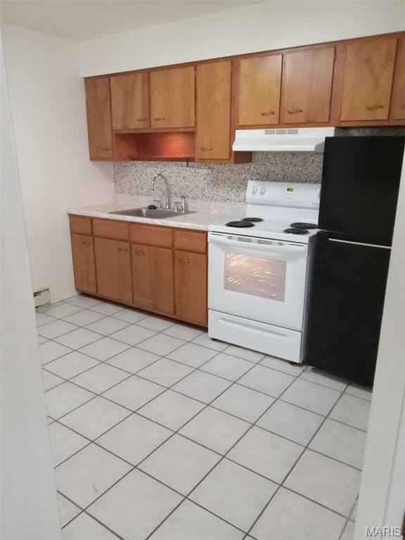 753 Rozier St, Saint Genevieve, MO 63670 - kitchen with white electric stove, under cabinet range hood, a sink, freestanding refrigerator, and light countertops
