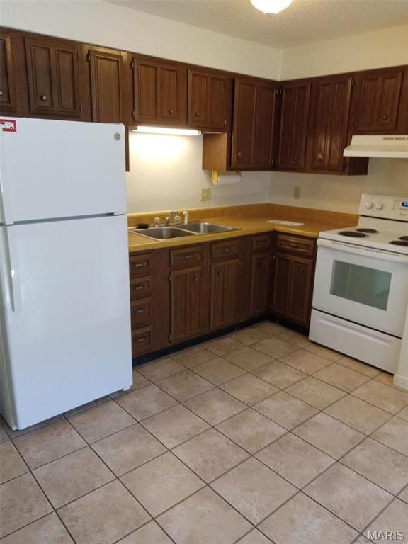 753 Rozier St, Saint Genevieve, MO 63670 - kitchen with white appliances, under cabinet range hood, a sink, light countertops, and light tile patterned floors