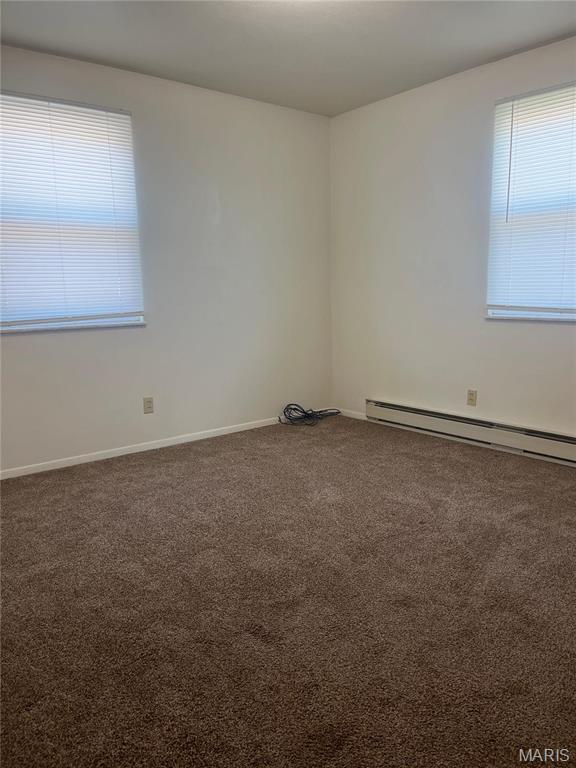 753 Rozier St, Saint Genevieve, MO 63670 - unfurnished room featuring carpet, baseboard heating, and baseboards