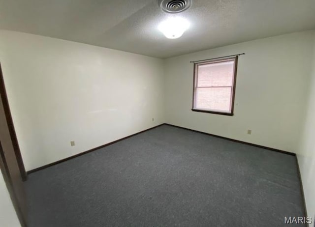753 Rozier St, Saint Genevieve, MO 63670 - empty room with baseboards, dark carpet, and a textured ceiling