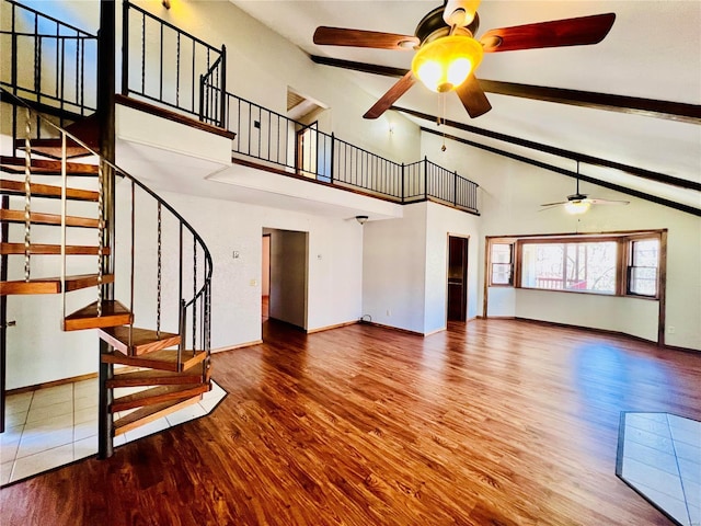 16144 Horse Shoe Dr, Houston, MO 65483 - unfurnished living room with a ceiling fan, wood finished floors, stairway, beamed ceiling, and baseboards
