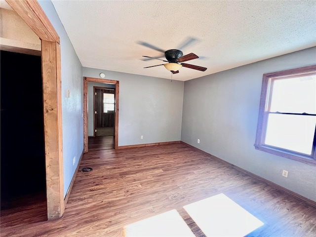 16144 Horse Shoe Dr, Houston, MO 65483 - unfurnished room featuring ceiling fan, a textured ceiling, wood finished floors, and baseboards