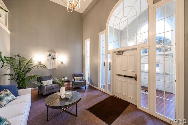 526 Sarah Ln Unit 35, Saint Louis, MO 63141 - living room featuring a high ceiling, carpet, and a chandelier