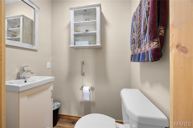 9136 Beach Dr, French Village, MO 63036 - half bath featuring toilet, vanity, and wood finished floors
