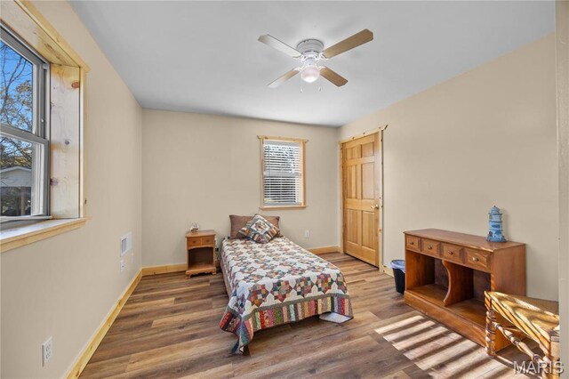 9136 Beach Dr, French Village, MO 63036 - bedroom featuring multiple windows, baseboards, wood finished floors, and ceiling fan