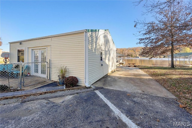 9136 Beach Dr, French Village, MO 63036 - view of property exterior featuring french doors, driveway, fence, and a patio