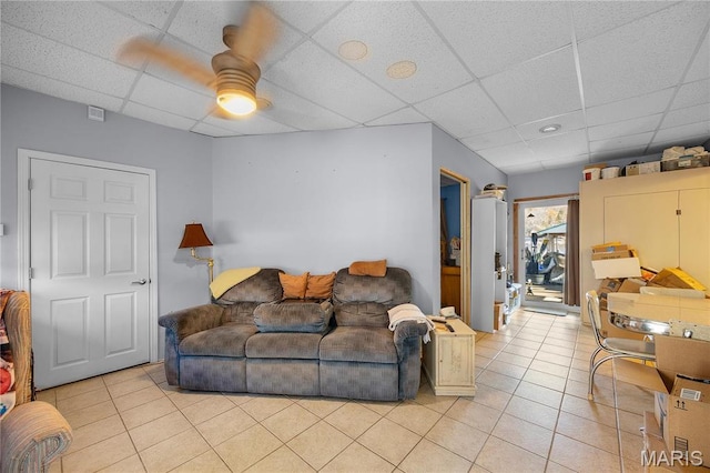 9136 Beach Dr, French Village, MO 63036 - living area with a paneled ceiling, light tile patterned floors, and ceiling fan