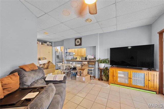 9136 Beach Dr, French Village, MO 63036 - living room with a drop ceiling, light tile patterned floors, and a ceiling fan