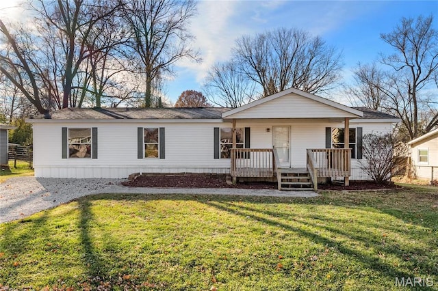 view of front of property with a porch, a front yard, and roof with shingles