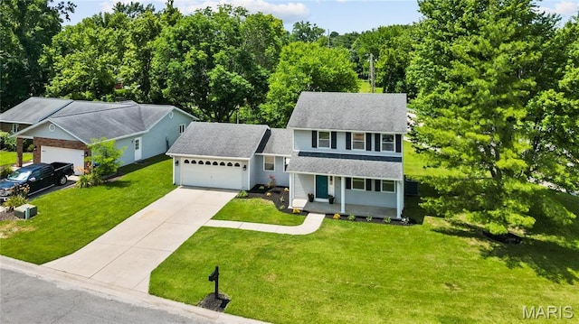 1 Germania, Columbia, IL 62236 - view of front of property with a porch, an attached garage, concrete driveway, a front yard, and roof with shingles