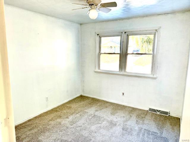 unfurnished room with carpet flooring, ceiling fan, and baseboards