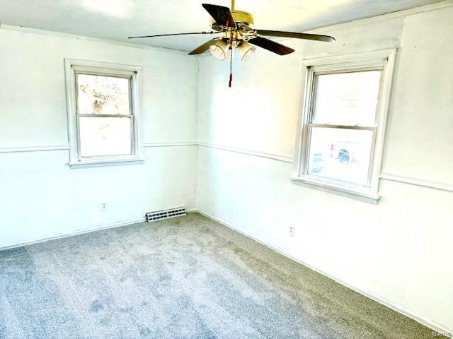 carpeted empty room featuring ceiling fan