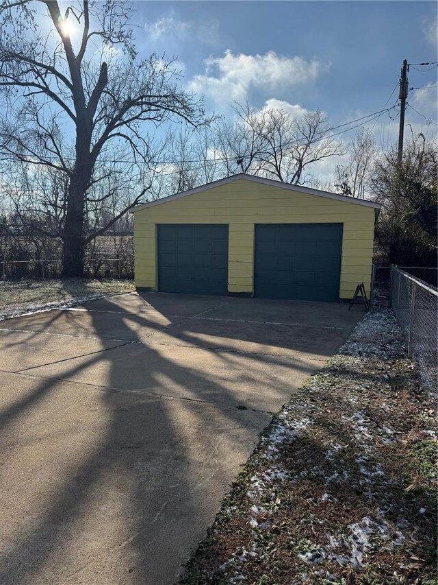 detached garage featuring fence