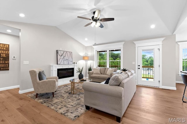 955 Half Moon Ln, Caseyville, IL 62232 - living area featuring lofted ceiling, a glass covered fireplace, a ceiling fan, light wood finished floors, and recessed lighting