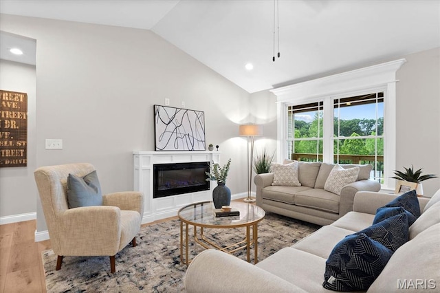 955 Half Moon Ln, Caseyville, IL 62232 - living room featuring wood finished floors, a glass covered fireplace, recessed lighting, and high vaulted ceiling