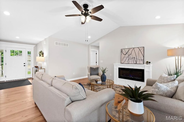 955 Half Moon Ln, Caseyville, IL 62232 - living room with wood finished floors, a glass covered fireplace, vaulted ceiling, recessed lighting, and a ceiling fan