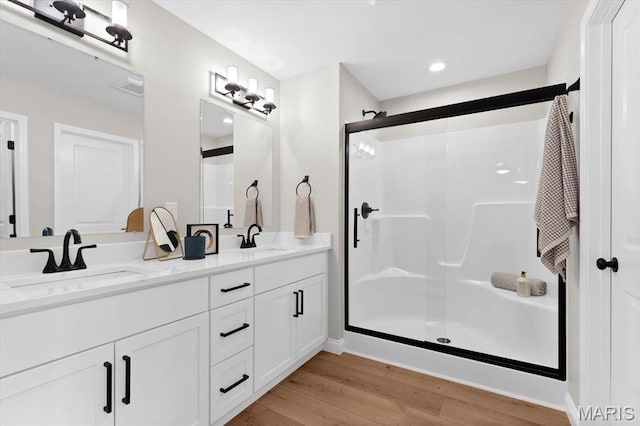 955 Half Moon Ln, Caseyville, IL 62232 - bathroom featuring wood finished floors, a stall shower, and double vanity