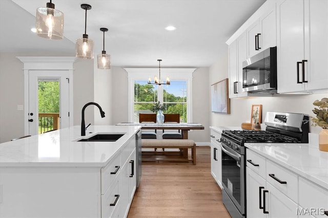 955 Half Moon Ln, Caseyville, IL 62232 - kitchen featuring stainless steel appliances, light wood finished floors, light countertops, a chandelier, and recessed lighting