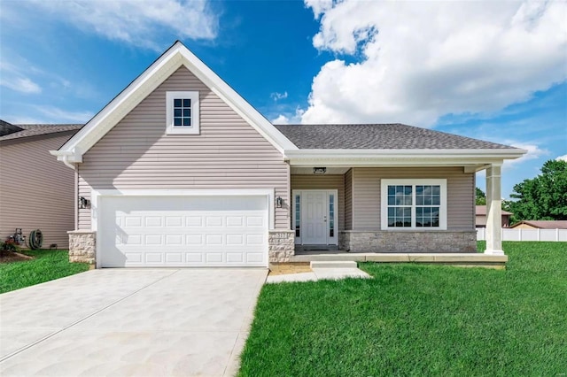 view of front of property with stone siding, concrete driveway, a front yard, and a shingled roof