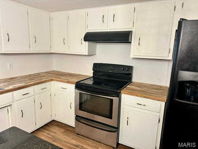 201 County Highway 331, Benton, MO 63736 - kitchen featuring ventilation hood, stainless steel range with electric stovetop, black fridge with ice dispenser, wooden counters, and wood finished floors
