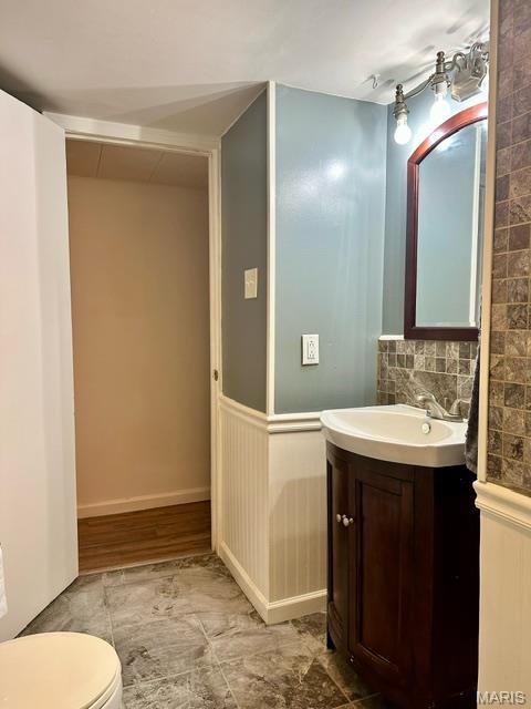 201 County Highway 331, Benton, MO 63736 - half bath featuring vanity, toilet, and tasteful backsplash