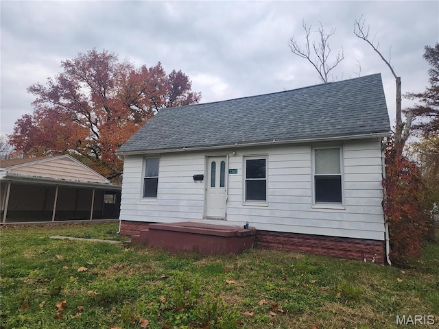 2365 E Converse Ave, Springfield, IL 62702 - back of property with a shingled roof, a yard, and a sunroom