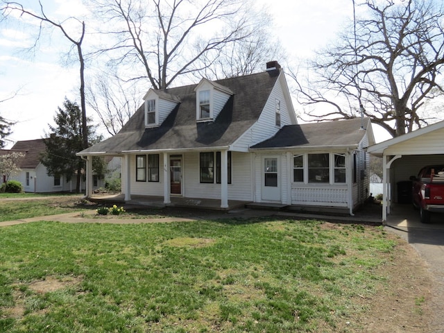 204 E Wayne St, Ironton, MO 63650 - view of front of house with a front yard, a porch, a chimney, a carport, and driveway
