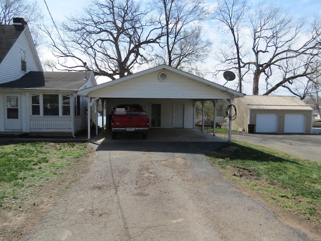 204 E Wayne St, Ironton, MO 63650 - view of front of property with a carport, an outbuilding, and driveway