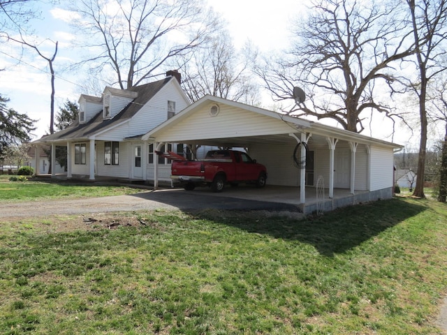 204 E Wayne St, Ironton, MO 63650 - view of side of home with driveway, a yard, covered porch, an attached carport, and a chimney
