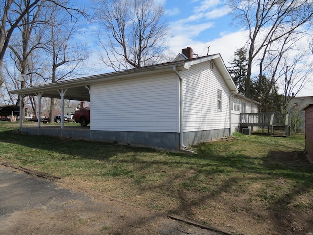 204 E Wayne St, Ironton, MO 63650 - view of side of property featuring a chimney, a carport, a yard, and a wooden deck