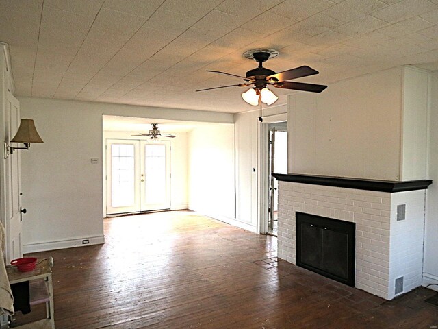 204 E Wayne St, Ironton, MO 63650 - unfurnished living room featuring wood-type flooring, a ceiling fan, a fireplace, and plenty of natural light