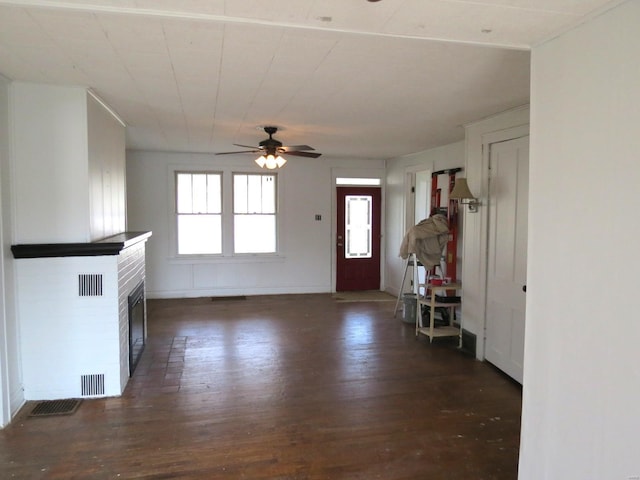 204 E Wayne St, Ironton, MO 63650 - unfurnished living room featuring wood finished floors, plenty of natural light, ceiling fan, and a brick fireplace