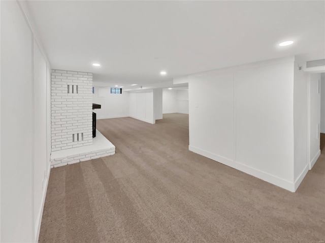 1673 Kingsford Dr, Florissant, MO 63031 - finished basement featuring light carpet, a fireplace, recessed lighting, and baseboards