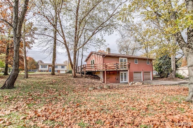23388 Glenda Ave, Jerseyville, IL 62052 - rear view of house with a garage, a chimney, a wooden deck, and driveway