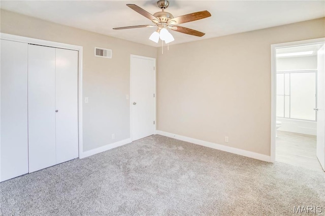 23388 Glenda Ave, Jerseyville, IL 62052 - unfurnished bedroom with carpet flooring, a closet, connected bathroom, and a ceiling fan