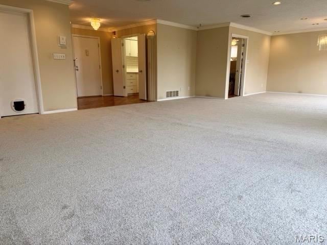10367 Oxford Hill Dr Unit 26, Saint Louis, MO 63146 - carpeted spare room with crown molding, baseboards, and a chandelier