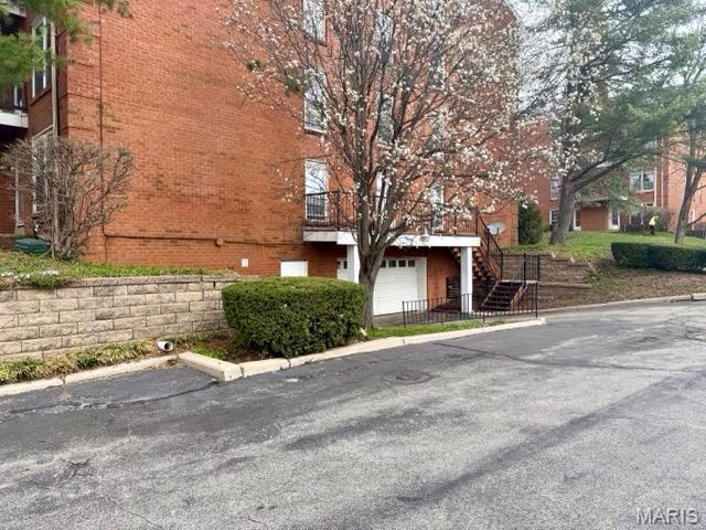 10367 Oxford Hill Dr Unit 26, Saint Louis, MO 63146 - view of asphalt street with stairs and curbs