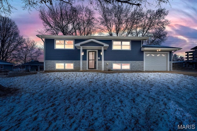 803 Fairview Dr, Washington, MO 63090 - bi-level home featuring a garage and stone siding