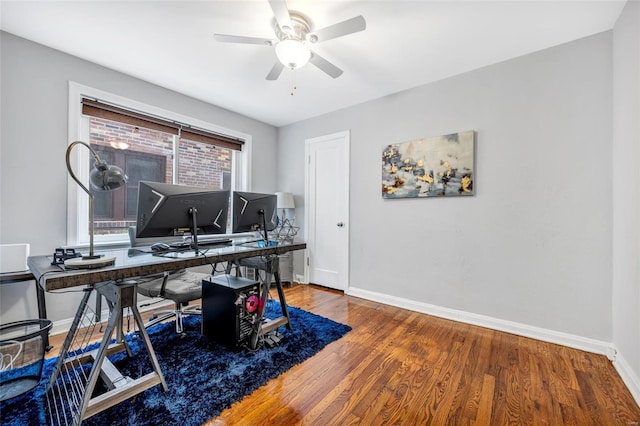 office area featuring baseboards, ceiling fan, and wood finished floors